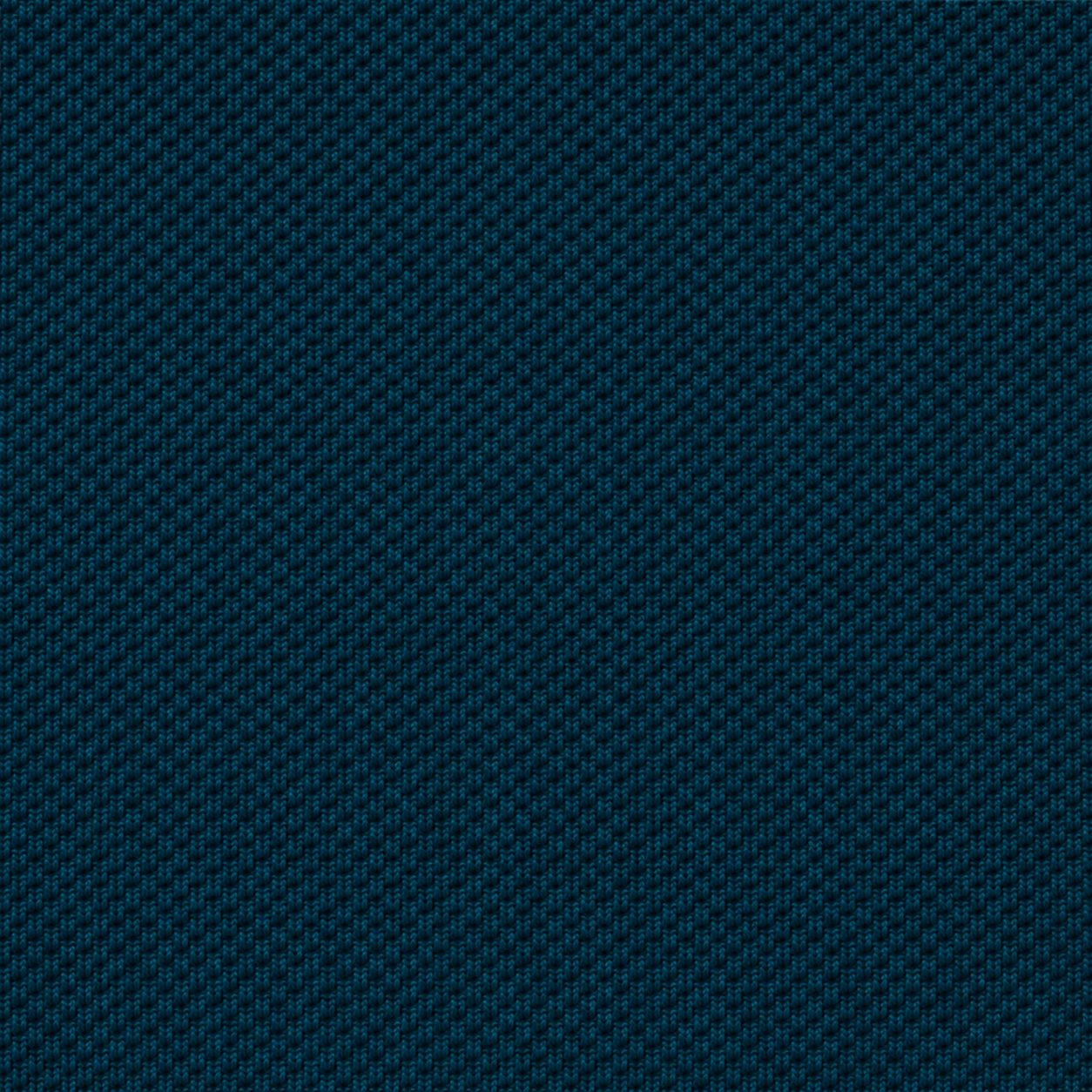 Macro close-up of deep teal piqué cotton weave showing the tight basket-weave structure of the 220GSM fabric
