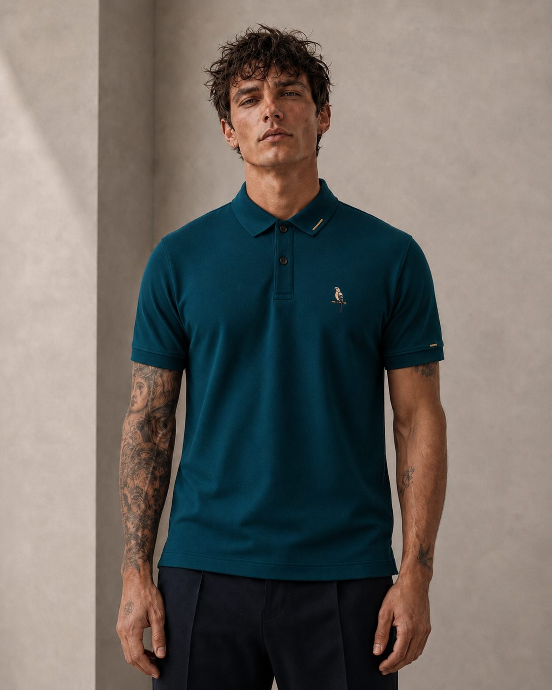 Model wearing the Parrot Polo in deep petrol teal, collar buttoned, sharper silhouette
